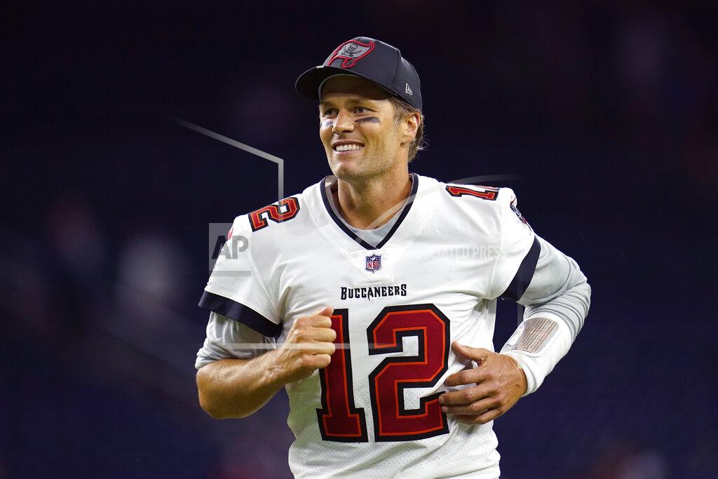 Matt Patterson FILE -Tampa Bay Buccaneers quarterback Tom Brady (12) smiles as he runs off the field after an NFL preseason football game against the Houston Texans, Saturday, Aug. 28, 2021, in Houston. Tom Brady will be on the hot seat – this time during a Netflix roast. Netflix announced Tuesday, May 17, 2022, the seven-time Super Bowl champion will be featured first in a series of upcoming specials called “Greatest Roasts of All Time: GROAT.” Brady is the executive producer of the series, with his roast set to tape in 2023. (AP Photo/Matt Patterson, File)