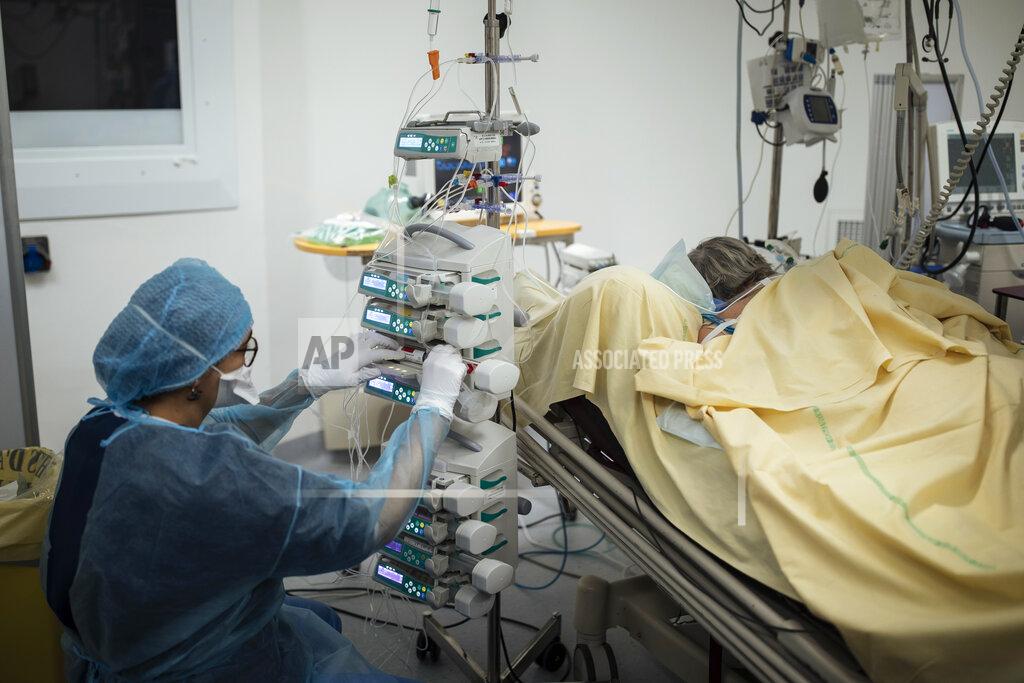 Lewis Joly Nurse Nadia Boudra cares for a patient inside an operating room now used for unconscious COVID-19 patients at Bichat Hospital, AP-HP, in Paris, Thursday, April 22, 2021. France still had nearly 6,000 critically ill patients in ICUs this week as the government embarked on the perilous process of gingerly easing the country out of its latest lockdown, too prematurely for those on pandemic frontlines in hospitals. President Emmanuel Macron's decision to reopen elementary schools on Monday and allow people to move about more freely again in May, even though ICU numbers have remained stubbornly higher than at any point since the pandemic's catastrophic first wave, marks another shift in multiple European capitals away from prioritizing hospitals. (AP Photo/Lewis Joly)