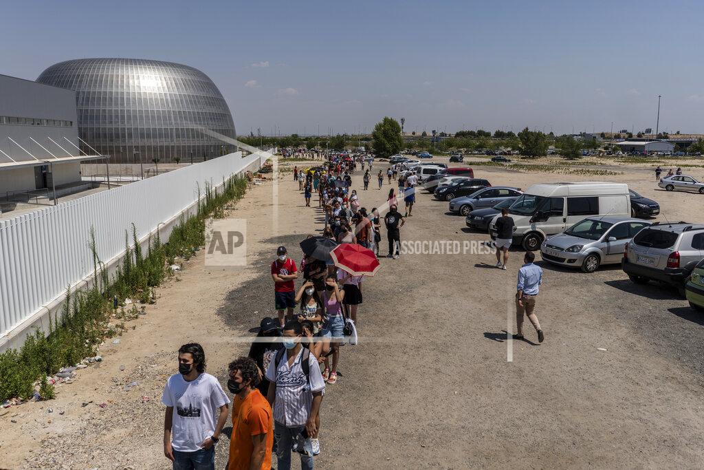 Olmo Calvo People queue to be vaccinated against COVID-19 at the Isabel Zendal Hospital in Madrid, Spain, Tuesday, July 20, 2021. Spain is trying to stamp out a new wave of COVID-19 among its youth thanks to a robust vaccination program that is widely supported. Spain like the rest of the European Union got off to a slow start to compared to the United States and Britain when the first vaccines were released. But it has quickly made up ground once deliveries by drug makers started flowing. (AP Photo/Olmo Calvo)