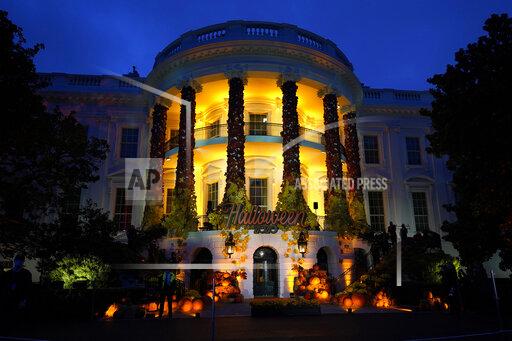 CORRECTS YEAR TO 2020, NOT 2021 - FILE - In this Oct. 25, 2020 file photo, the South Lawn of the White House is lit during a Halloween celebration at the White House in Washington. Ghosts and goblins can scratch the White House from their trick or treating routes this year. President Joe Biden and first lady Jill Biden will be in Europe on Halloween and won't be around to help hand out candy and other treats. Instead, the first lady's spokesperson says the Pennsylvania Avenue side of the White House will be lit up in orange to celebrate the spooky holiday. (AP Photo/Manuel Balce Ceneta)