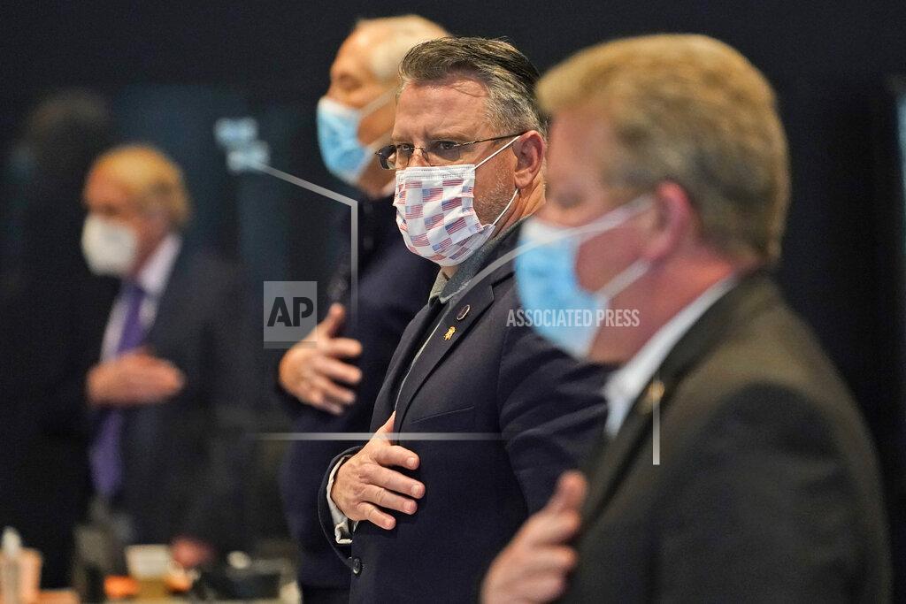 Steve Helber Virginia State Sens. Bryce Reeves, R-Spotsylvania, center, David Marsden, D-Fairfax, left, and Bill Stanley, R-Franklin County, recite the Pledge of Allegiance during the Senate session at the Science Museum in Richmond, Va., Thursday, Feb. 18, 2021. (AP Photo/Steve Helber)
