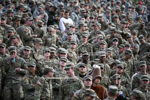 Cadets attend the NCAA college football game between the Army Black Knights and Massachusetts at Michie Stadium, Saturday, Nov. 20, 2021, in West Point, N.Y. The U.S. military academies provide a key pipeline into the leadership of the armed services and have welcomed more racially diverse students each year for the better part of the last decade. (AP Photo/Eduardo Munoz Alvarez)