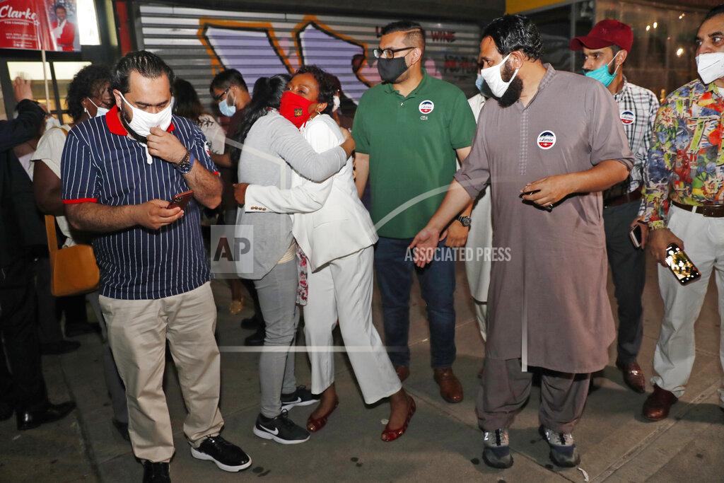 Kathy Willens Rep. Yvette Clarke, D-N.Y., in white, embraces a Muslim supporter as other Muslims from Clarke's district gather outside her campaign headquarters Tuesday, June 23, 2020, in the Brooklyn borough of New York, on primary night. (AP Photo/Kathy Willens)
