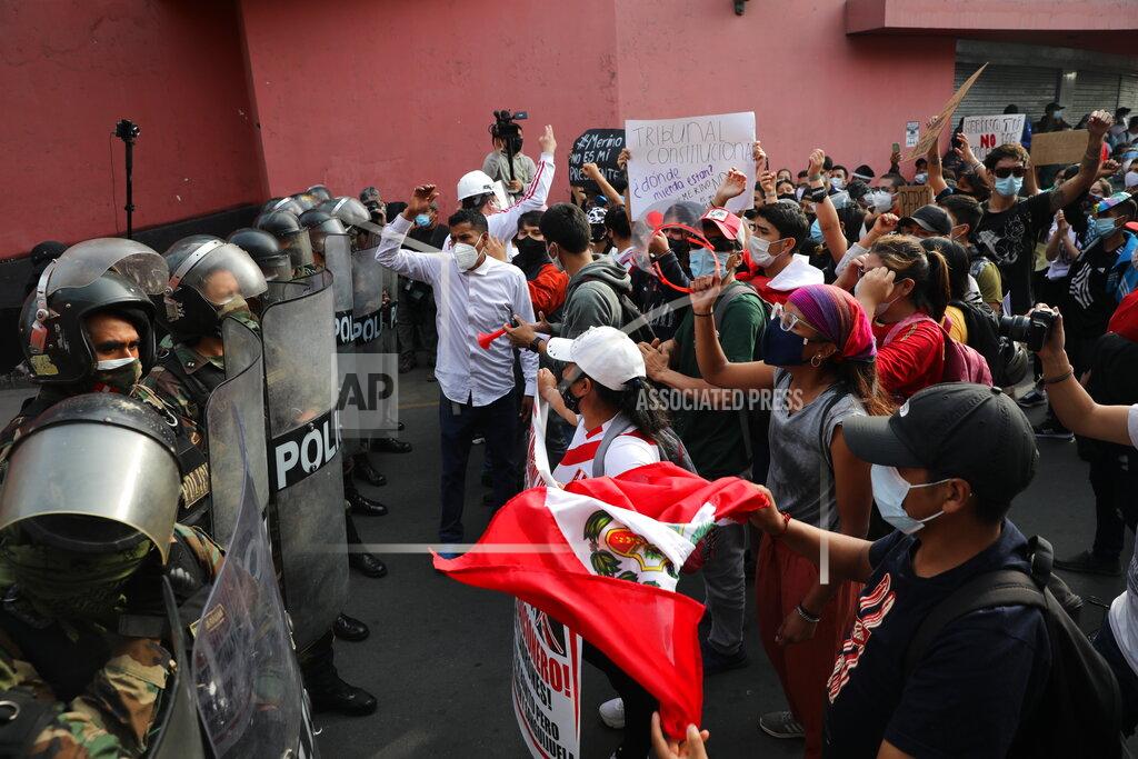 Rodrigo Abd Supporters of ousted President Martin Vizcarra shout at police to let them pass as they try to march to Congress in Lima, Peru, Wednesday, Nov. 11, 2020. On Tuesday, Peru swore in Manuel Merino as president, after Peru’s legislature booted Vizcarra from office on Monday. (AP Photo/Rodrigo Abd)