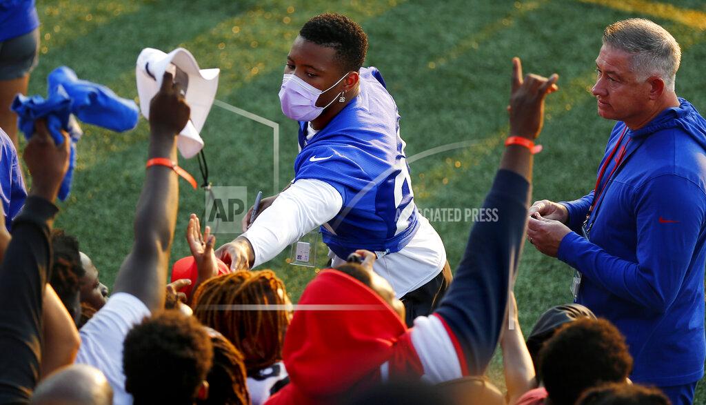 John Munson New York Giants' Saquon Barkley signs autographs for fans following the team's NFL training camp at Eddie Moraes Stadium, Saturday, July 31, 2021, in Newark, N.J. (AP Photo/John Munson)