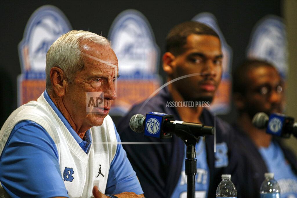 Nell Redmond North Carolina coach Roy Williams, left, answers a question during the Atlantic Coast Conference NCAA college basketball media day in Charlotte, N.C., Tuesday, Oct. 8, 2019. (AP Photo/Nell Redmond)