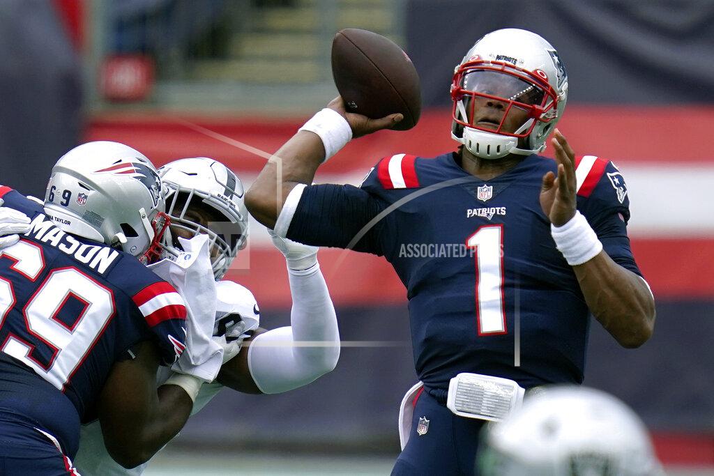 Charles Krupa New England Patriots quarterback Cam Newton (1) passes under pressure in the first half of an NFL football game against the Las Vegas Raiders, Sunday, Sept. 27, 2020, in Foxborough, Mass. (AP Photo/Charles Krupa)