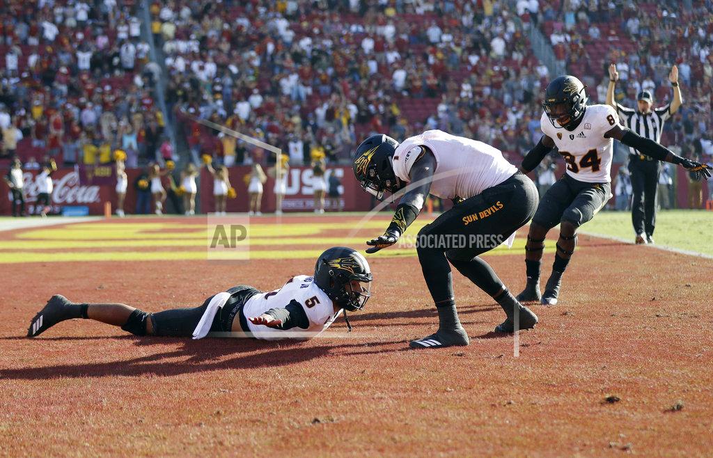 Marcio Jose Sanchez Arizona State quarterback Manny Wilkins, bottom, left, celebrates with teammates in the end zone after his rushing touchdown against Southern California during the second half of an NCAA college football game Saturday, Oct. 27, 2018, in Los Angeles. (AP Photo/Marcio Jose Sanchez)