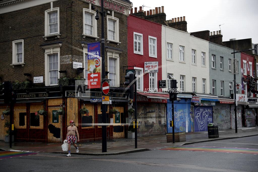 Matt Dunham A man walks past temporarily closed shops and a pub in Camden Town, an area of London usually bustling with tourists and visitors to its market, Tuesday, Jan. 12, 2021, during England's third national lockdown since the coronavirus outbreak began. Britain, with over 81,000 dead, has the deadliest virus toll in Europe and the number of hospital beds filled by COVID-19 patients has risen steadily for more than a month. (AP Photo/Matt Dunham)