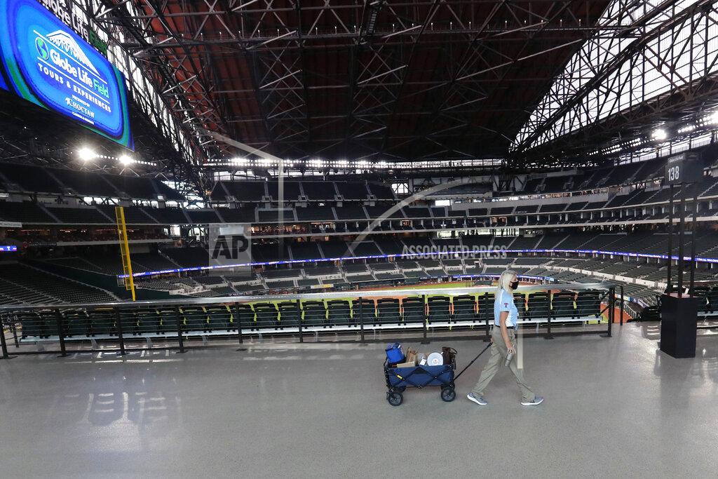 Lm Otero A Texas Rangers employee pulls a cart down an empty concourse at Globe Life Field, home of the Texas Rangers baseball team, in Arlington, Texas, Monday, June 1, 2020. It used to be that empty seats caused palpitations in team owners and college administrators relying on ticket sales and concessions to balance the budget. Now, those empty seats, and short lines and clear concourses, will be the norm for a while as sports grapples with social distancing requirements in the age of coronavirus. (AP Photo/LM Otero)