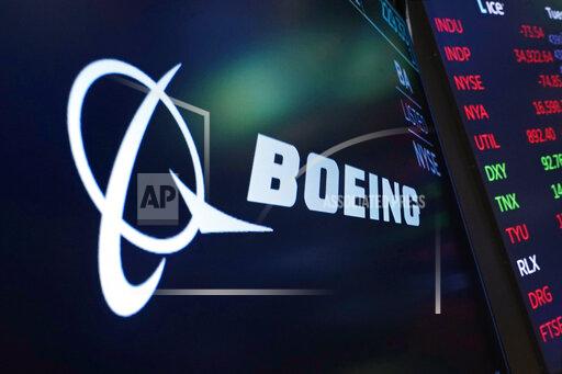 FILE - The logo for Boeing appears on a screen above a trading post on the floor of the New York Stock Exchange, Tuesday, July 13, 2021. Boeing is reporting a loss of $109 million for the third quarter as it struggles to resume deliveries of the 787, a large plane that is popular on international airline routes. The loss that Boeing reported Wednesday, Oct. 27, 2021 is narrower than a year ago, however. (AP Photo/Richard Drew, file)