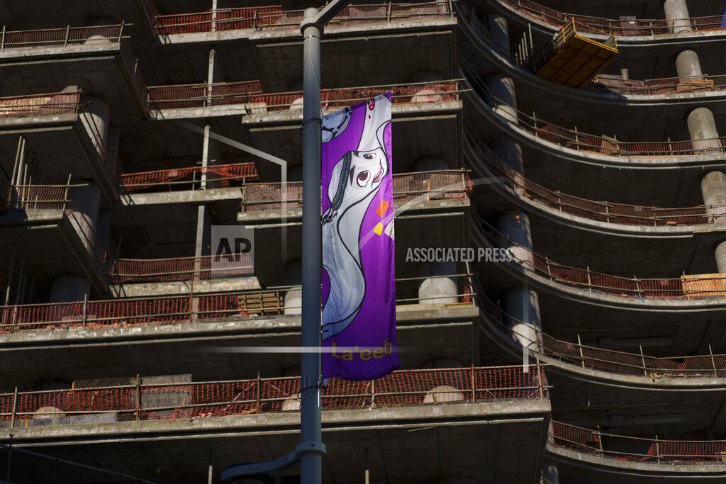 Pavel Golovkin A flag hangs from a building under construction in Lusail downtown, Qatar, Thursday, Nov. 24, 2022. (AP Photo/Pavel Golovkin)