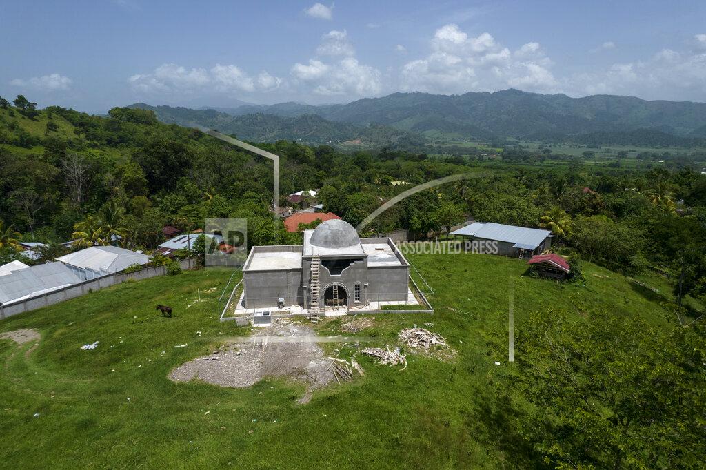 Rodrigo Abd An aerial view shows the property of drug trafficker Nery Orlando Lopez Sanabria, where he is buried in the mausoleum, center, still under construction, after he was killed in a prison riot, in the Santa Barbara department of Honduras, Thursday, July 15, 2021. More than 1,000 people are stranded in this area marked by poverty and drug violence that have driven so many Hondurans to the United States. (AP Photo/Rodrigo Abd)