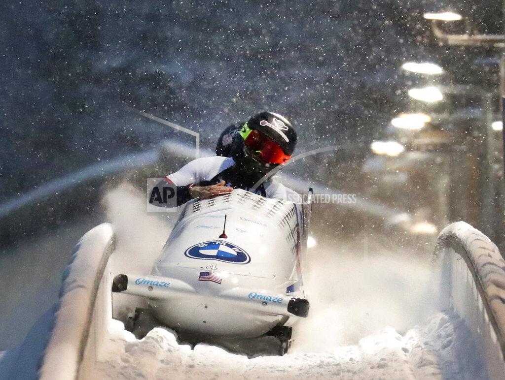 Kaillie Humphries and Lolo Jones of the United States celebrate after winning the two women's bobsleigh race at the Bobsleigh and Skeleton World Championships in Altenberg, Germany, Saturday, Feb. 6, 2021. (AP Photo/Matthias Schrader)