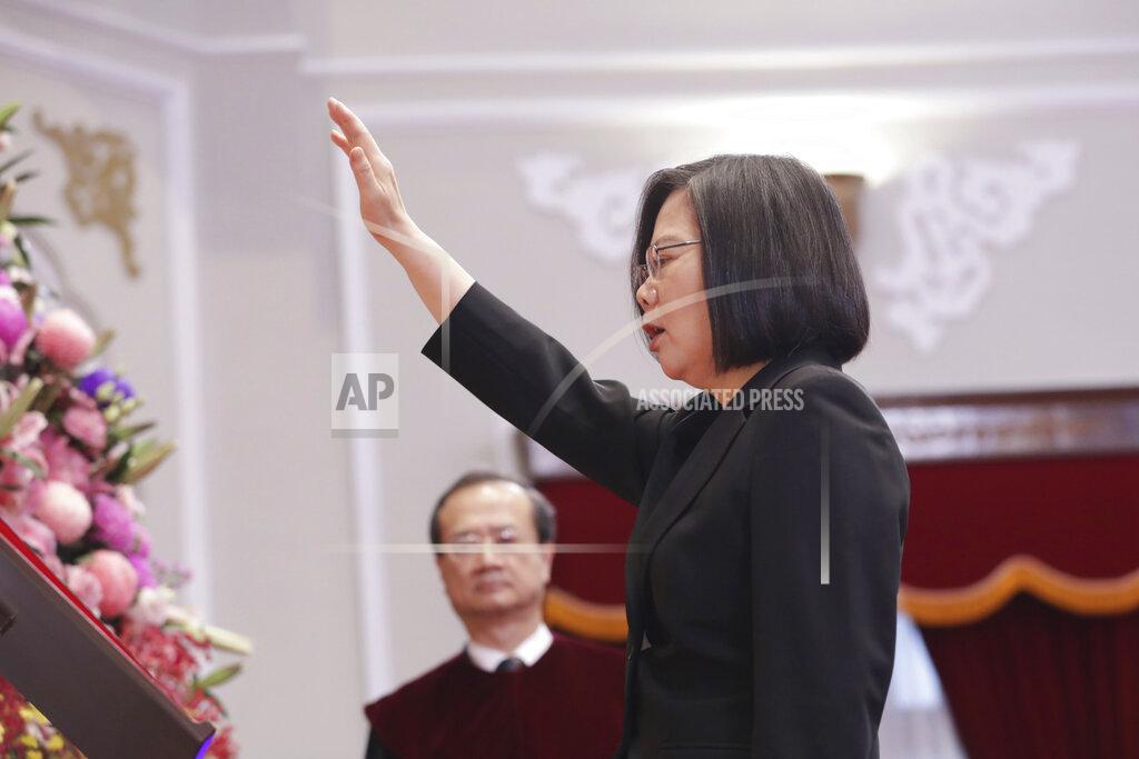 Uncredited In this photo released by the Taiwan Presidential Office, Taiwanese President Tsai Ing-wen raises her hand during an inauguration ceremony at the Presidential office in Taipei, Taiwan Wednesday, May 20, 2020. President Tsai been inaugurated for a second term amid increasing pressure from China on the self-governing island democracy it claims as its own territory. (Taiwan Presidential Office via AP)
