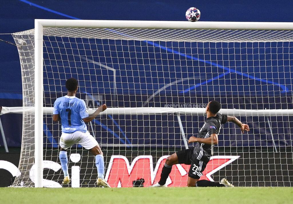 Franck Fife Manchester City's Raheem Sterling, left, puts the ball over the bar during the Champions League quarterfinal match between Manchester City and Lyon at the Jose Alvalade stadium in Lisbon, Portugal, Saturday, Aug. 15, 2020. (Franck Fife/Pool Photo via AP)