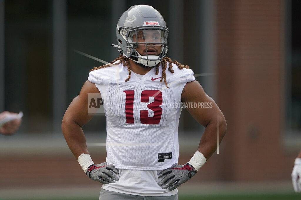 Ted S. Warren Washington State linebacker Jahad Woods takes part in the first day of NCAA college football practice, Friday, Aug. 6, 2021, in Pullman, Wash. WSU head coach Nick Rolovich would like for attention going into the 2021 season to be focused on players on the field, but he is getting just as much attention around his decision not to receive a COVID-19 vaccination.(AP Photo/Ted S. Warren)