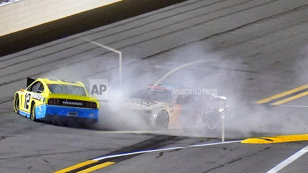 Chris O'meara Drivers Ryan Blaney (12) and Chase Elliott (9) crash during the final lap of the NASCAR Daytona Clash auto race Tuesday, Feb. 9, 2021, at Daytona International Speedway in Daytona Beach, Fla. (AP Photo/Chris O'Meara)