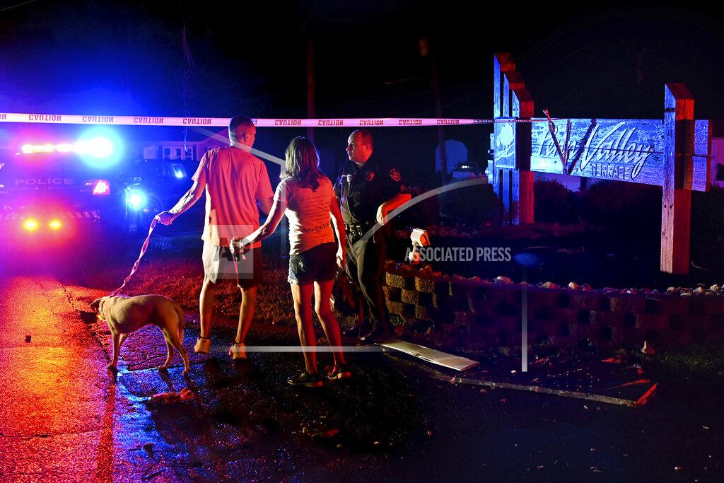 Tom Gralish Residents of the Penn Valley Terrace trailer park try to cross police lines to return to their homes after a tornado hit in Trevose, Pa. Thursday, July 29, 2021. Five people were injured Thursday when a building at a Bensalem auto dealership was destroyed by severe weather, authorities said. The National Weather Service confirmed two tornados touched down in Bucks County, sending trees falling and debris flying.(Tom Gralish/The Philadelphia Inquirer via AP)