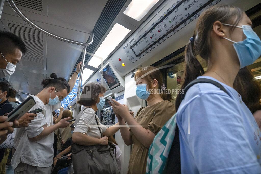Mark Schiefelbein People wearing face masks to protect against COVID-19 ride on a subway train during the morning rush hour in Beijing, Wednesday, Aug. 4, 2021. The coronavirus’s delta variant is challenging China’s costly strategy of isolating cities, prompting warnings that Chinese leaders who were confident they could keep the virus out of the country need a less disruptive approach. (AP Photo/Mark Schiefelbein)