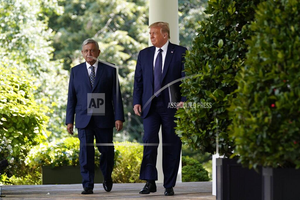 Evan Vucci President Donald Trump and Mexican President Andres Manuel Lopez Obrador arrive for an event in the Rose Garden at the White House, Wednesday, July 8, 2020, in Washington. (AP Photo/Evan Vucci)