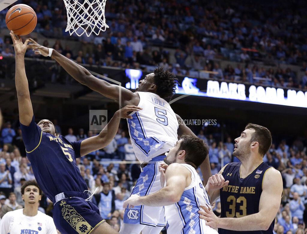 Gerry Broome North Carolina's Nassir Little (5) blocks Notre Dame's D.J. Harvey as John Mooney (33) and North Carolina's Luke Maye watch during the second half of an NCAA college basketball game in Chapel Hill, N.C., Tuesday, Jan. 15, 2019. North Carolina won 75-69. (AP Photo/Gerry Broome)