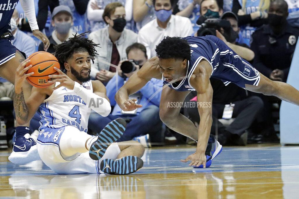 Chris Seward North Carolina guard R.J. Davis (4) and Duke guard Jeremy Roach scramble for a loose ball during the second half of an NCAA college basketball game, Saturday, Feb. 5, 2022, in Chapel Hill, N.C. (AP Photo/Chris Seward)