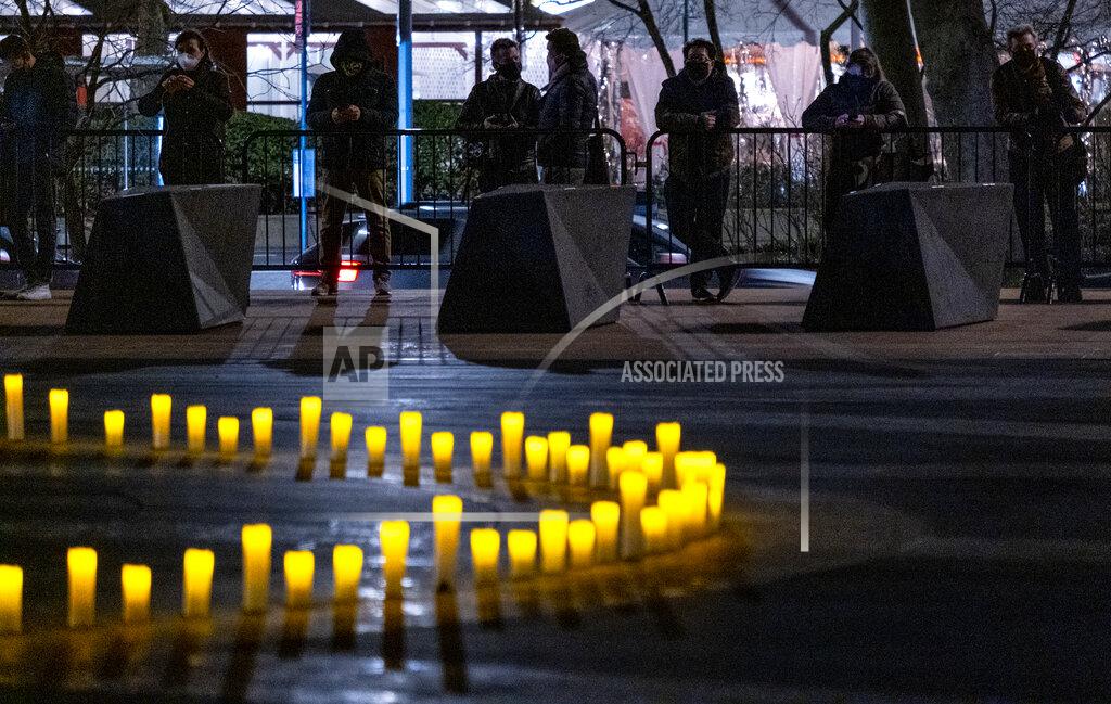 Craig Ruttle Revson Fountain is lit during a ceremony at Lincoln Center in New York Sunday, March 14, 2021, honoring those who were lost and marking a year after COVID-19 brought much of normal life in New York and the nation to a halt. (AP Photo/Craig Ruttle)