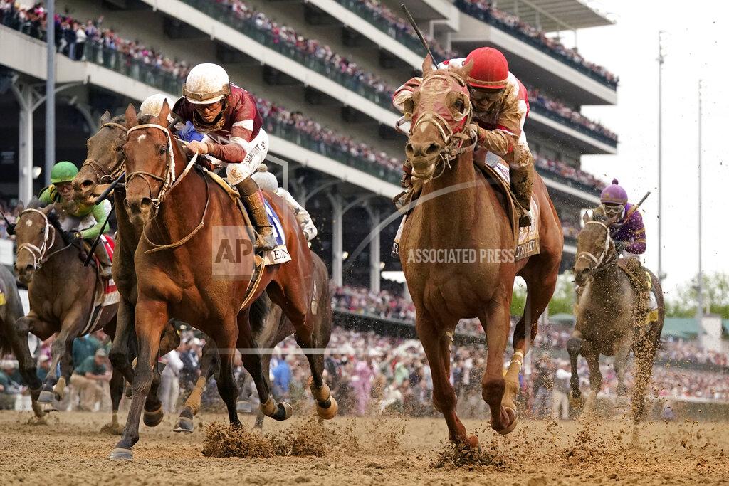 Jeff Roberson Sonny Leon rides Rich Strike, center, across the finish line to win the 148th running of the Kentucky Derby horse race at Churchill Downs Saturday, May 7, 2022, in Louisville, Ky. (AP Photo/Jeff Roberson)