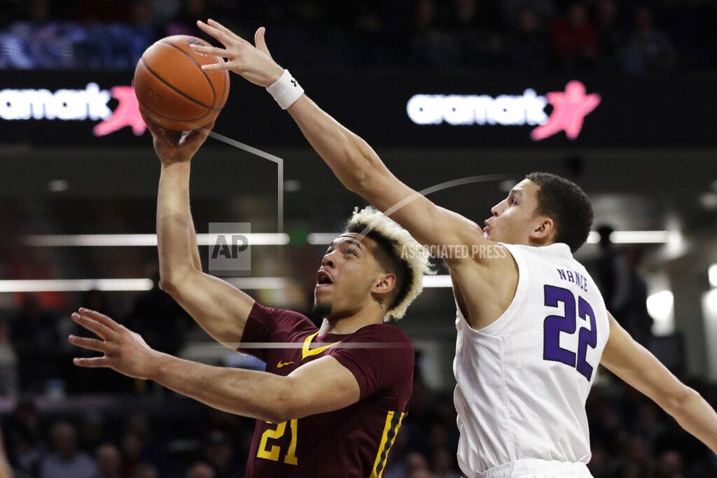 Nam Y. Huh Minnesota forward Jarvis Omersa, left, shoots against Northwestern forward Pete Nance during the first half of an NCAA college basketball game in Evanston, Ill., Sunday, Feb. 23, 2020. (AP Photo/Nam Y. Huh)