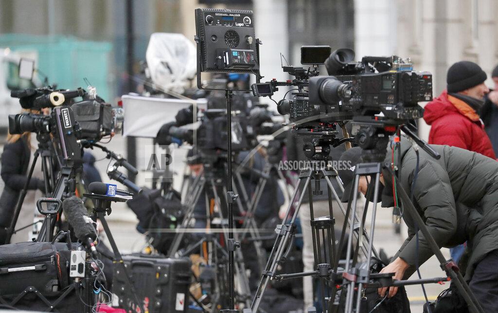 Frank Augstein Members of the media stand outside the main entrance of St Bartholomew's Hospital where Britain's Prince Philip is being treated in London, Friday, March 5, 2021. Buckingham Palace says Prince Philip has had a successful heart procedure in a London hospital. The palace says the 99-year-old Duke of Edinburgh, the husband of Queen Elizabeth II, "underwent a successful procedure for a pre-existing heart condition at St Bartholomew's Hospital." (AP Photo/Frank Augstein)