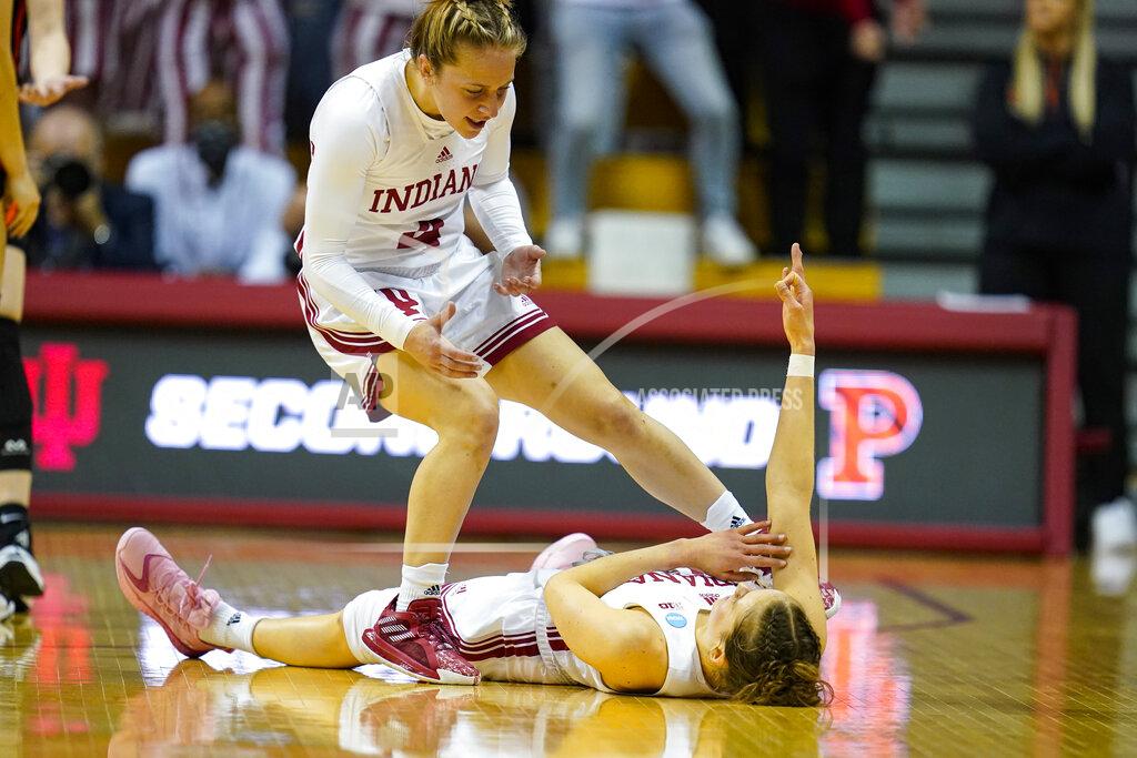 Michael Conroy Indiana guard Ali Patberg (14) celebrates on the floor with guard Nicole Cardano-Hillary (4) after being fouled on a shot by Princeton in the first half of a college basketball game in the second round of the NCAA tournament in Bloomington, Ind., Monday, March 21, 2022. (AP Photo/Michael Conroy)