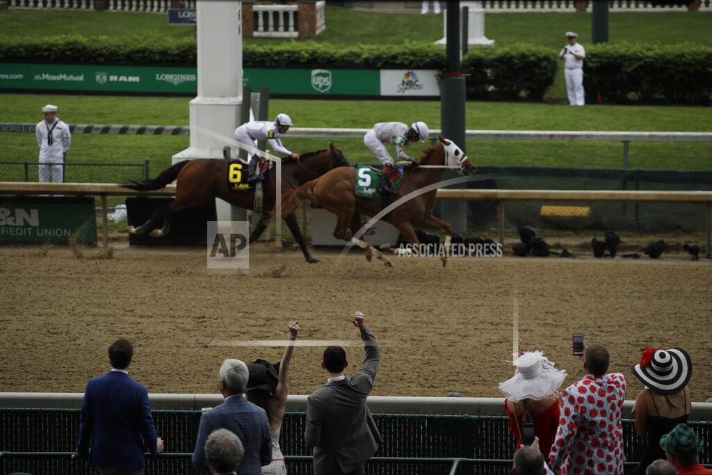 Charlie Riedel People cheer as they watch a race at Churchill Downs before the 145th running of the Kentucky Derby horse race Saturday, May 4, 2019, in Louisville, Ky. (AP Photo/Charlie Riedel)