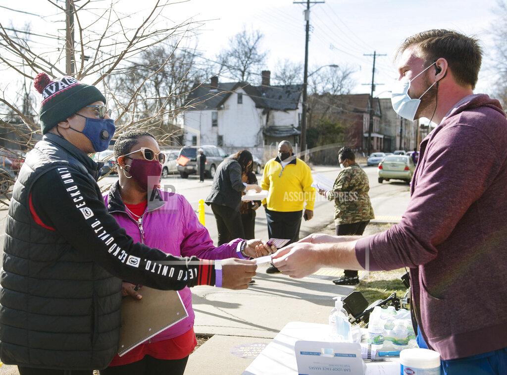 Emily Matthews Theodore and Donella Jackson, of the North Side in Pittsburgh, get checked in by Tyler Hoffman, a pharmacy fellow with UPMC, before receiving the Moderna vaccine during a COVID-19 vaccine event on Saturday, March 13, 2021, at Bethany Community Ministries in Homewood, Pa. (Emily Matthews/Pittsburgh Post-Gazette via AP)