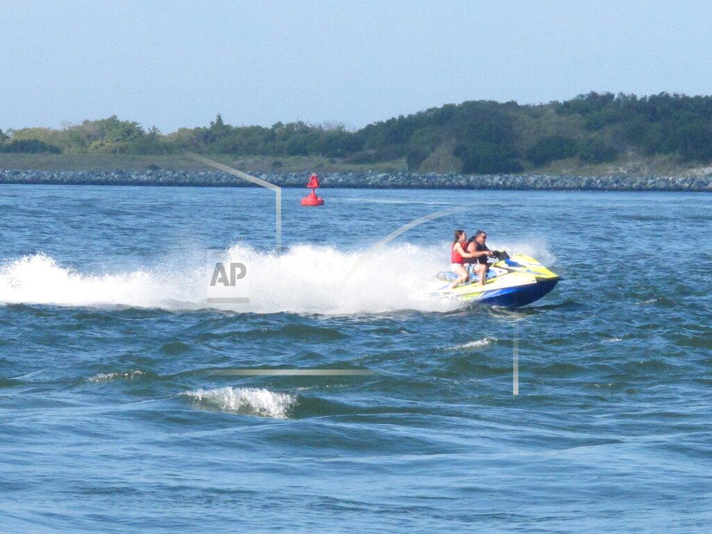Wayne Parry This Sept. 18, 2021 photo shows people piloting a personal water craft through the Barnegat Inlet in Barnegat Light N.J. where a storm gate would be constructed across the inlet as part of a $16 billion storm control project being proposed by the U.S. Army Corps of Engineers. A public hearing on the proposal was to be held on Tuesday, Sept. 21. (AP Photo/Wayne Parry)