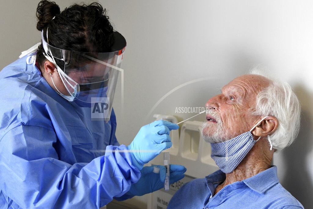 Taimy Alvarez National Institutes of Health-funded Moderna COVID-19 vaccine study participant William Webb, right, gets a COVID-19 nose swab test by University of Miami Miller School of Medicine nurse Loreta Padron, Wednesday, Sept. 2, 2020 in Miami. Miami is one of 89 cities around the U.S. that's testing the Moderna COVID-19 vaccine. (AP Photo/Taimy Alvarez)