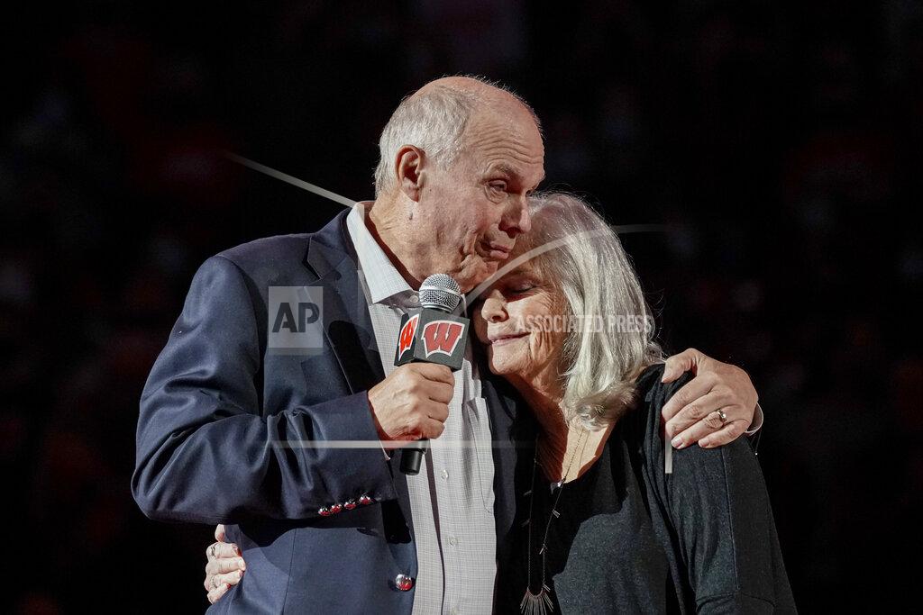Andy Manis Bo Ryan, a former Wisconsin basketball coach, and his wife Kelly Ryan hug during a ceremony to celebrate the coach's 15 seasons as the head coach in a ceremony at halftime at an NCAA college basketball game between Wisconsin and Wisconsin-Green Bay Friday, Nov. 12, 2021, in Madison, Wis. Ryan led Wisconsin to a school-record of 364 wins in 15 seasons. Ryan's collegiate career coaching record is 747-233. (AP Photo/Andy Manis)