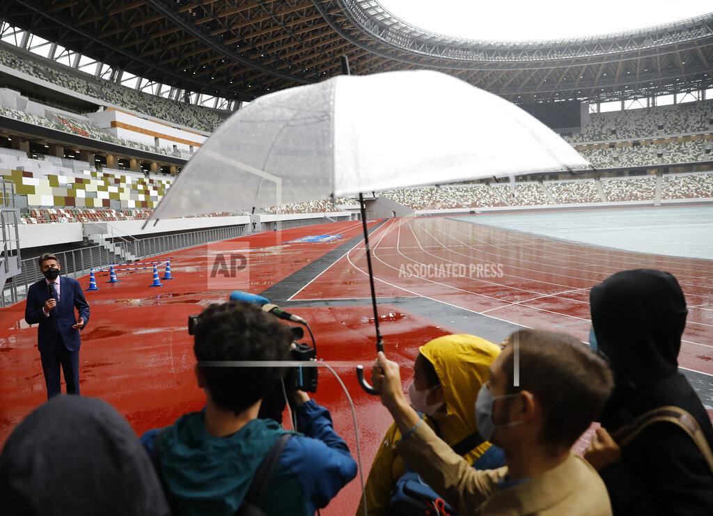 Issei Kato World Athletics President Sebastian Coe, top left, wearing a protective face mask speaks to media as he inspects at the National Stadium, the main stadium of Tokyo 2020 Olympics and Paralympics, in Tokyo Thursday, Oct. 8, 2020. (Issei Kato/Pool Photo via AP)