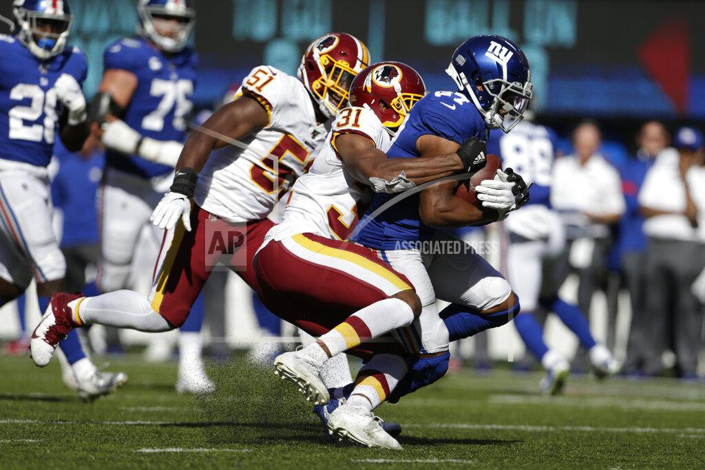 Adam Hunger Washington Redskins' Fabian Moreau (31), center, tries to take down New York Giants' Sterling Shepard during the second half of an NFL football game, Sunday, Sept. 29, 2019, in East Rutherford, N.J. (AP Photo/Adam Hunger)