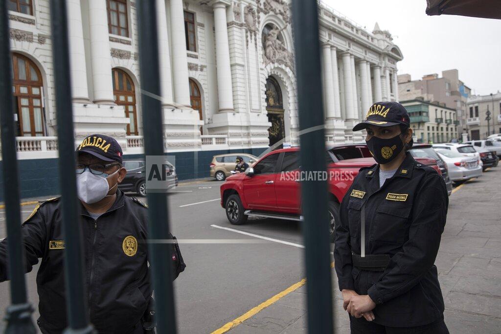 Rodrigo Abd Police stand guard outside Congress in Lima, Peru, Friday, Sept. 18, 2020. Peruvian President Martin Vizcarra's job is on the line Friday as opposition lawmakers push through an impeachment hearing criticized as a hasty and poorly timed ouster attempt in one of the countries hardest hit by the coronavirus pandemic. (AP Photo/Rodrigo Abd)