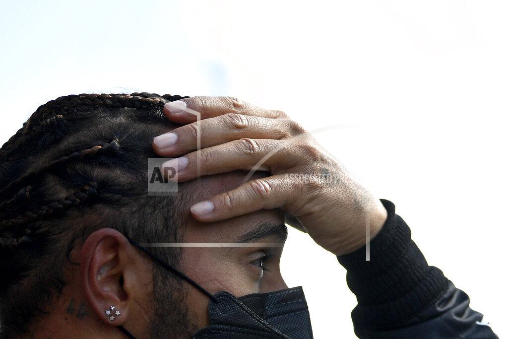 Gabriel Buoys Mercedes driver Lewis Hamilton of Britain reacts after he clocked the second fastest time during the qualifying session ahead of the Portugal Formula One Grand Prix at the Algarve International Circuit near Portimao, Portugal, Saturday, May 1, 2021. The Portugal Grand Prix will be held on Sunday. (Gabriel Buoys/Pool via AP)