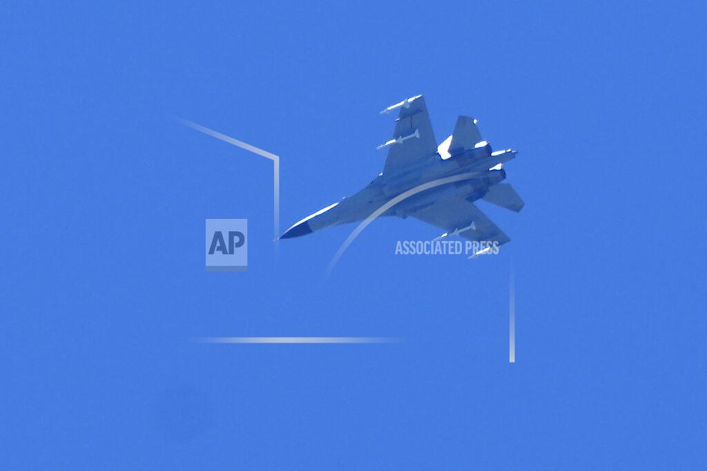 Ng Han Guan A fighter jet flies in the direction of Taiwan seen from the 68-nautical-mile scenic spot, the closest point in mainland China to the island of Taiwan, in Pingtan in southeastern China's Fujian Province, Friday, Aug. 5, 2022. China says it summoned European diplomats in the country to protest statements issued by the Group of Seven nations and the European Union criticizing threatening Chinese military exercises surrounding Taiwan. (AP Photo/Ng Han Guan)
