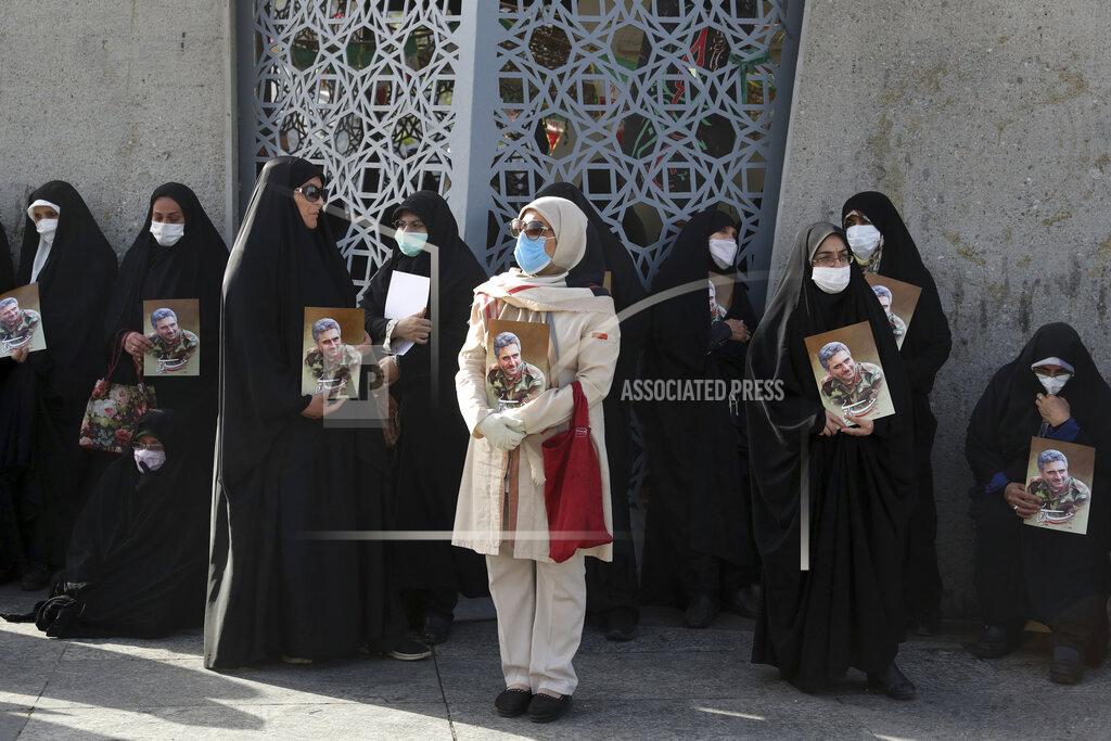 Vahid Salemi Mourners hold posters of Iran's Revolutionary Guard Col. Hassan Sayyad Khodaei who was killed on Sunday, in his funeral ceremony in Tehran, Iran, Tuesday, May 24, 2022. Iran's hard-line President Ebrahim Raisi vowed revenge on Monday over the killing of Sayyad Khodaei who was shot at his car by two assailants outside his home in Tehran, a still-mysterious attack on the country's powerful paramilitary force. (AP Photo/Vahid Salemi)