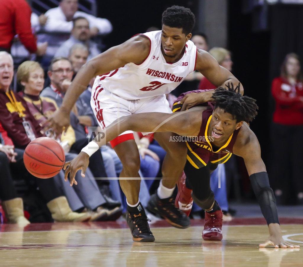 Andy Manis Wisconsin's Khalil Iverson (21) and Minnesota's Daniel Oturu (25) go after a loose ball during the second half of an NCAA college basketball game Thursday, Jan. 3, 2019, in Madison, Wis. Minnesota won 59-52. (AP Photo/Andy Manis)