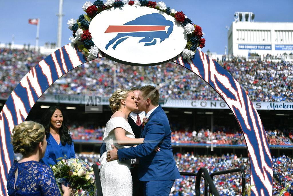 Adrian Kraus Mackenzie Park and Jordan Binggeli share a kiss after being married during a wedding ceremony at midfield during halftime of an NFL football game between the Buffalo Bills and the New England Patriots, Sunday, Sept. 29, 2019, in Orchard Park, N.Y. (AP Photo/Adrian Kraus)