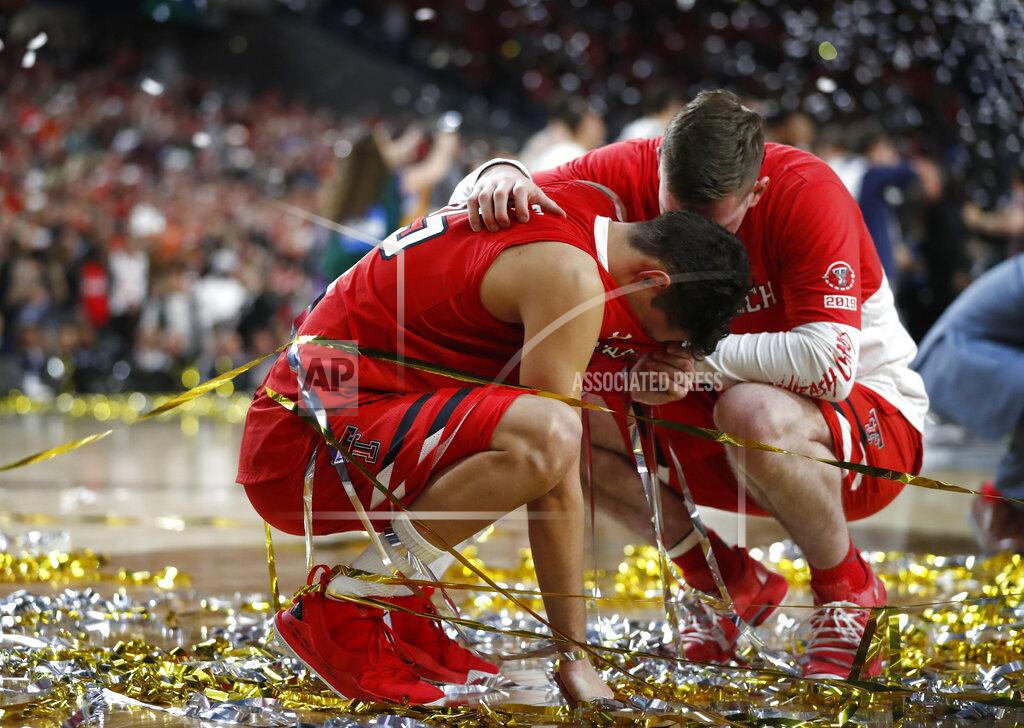 Jeff Roberson FILE - In this April 8, 2019, file photo, Texas Tech guard Davide Moretti, left, reacts with a teammate at the end of the championship game against Virginia in the Final Four NCAA college basketball tournament, in Minneapolis. The course of overtime changed when a Virginia player knocked the ball out of Texas Tech guard Davide Moretti's hands and sent the ball out of bounds. But the call was reversed when replay showed Moretti's finger had barely grazed the ball on its way out. (AP Photo/Jeff Roberson, File)