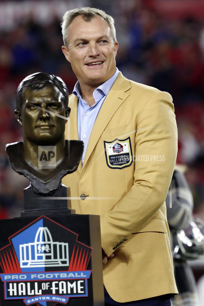 Mark Lomoglio Former Tampa Bay Buccaneers safety John Lynch poses next to his Hall of Fame bust during halftime of an NFL football game against the New York Giants Monday, Nov. 22, 2021, in Tampa, Fla. (AP Photo/Mark LoMoglio)