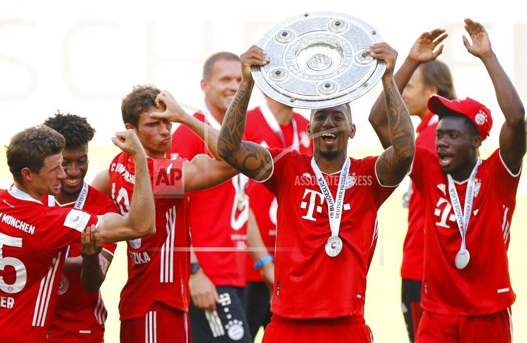 Kai Pfaffenbach Munich's Jerome Boateng lifts the trophy after the German Bundesliga soccer match between VfL Wolfsburg and FC Bayern Munich in Wolfsburg, Germany, Saturday, June 27, 2020. Bayern wins the 8th straight Bundesliga title. (Kai Pfaffenbach/Pool Photo via AP)