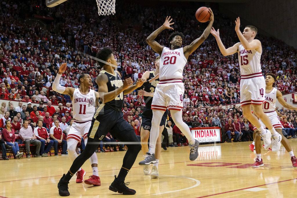 Aj Mast Indiana forward De'Ron Davis (20) pulls down a rebound in front of teammate Zach McRoberts (15) and Purdue guard Nojel Eastern (20) during the first half of an NCAA college basketball game in Bloomington, Ind., Tuesday, Feb. 19, 2019. (AP Photo/AJ Mast)