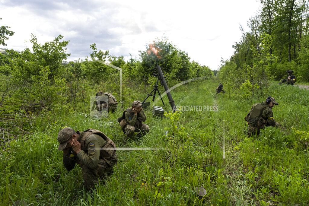Bernat Armangue Ukrainian servicemen accompanied by members of the foreign legion fire mortars at Russian positions in the eastern region of Kharkiv, Ukraine, Tuesday, May 17, 2022. (AP Photo/Bernat Armangue)